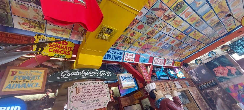 signs on the walls and ceilings of Guadalajara Grill in San Antonio